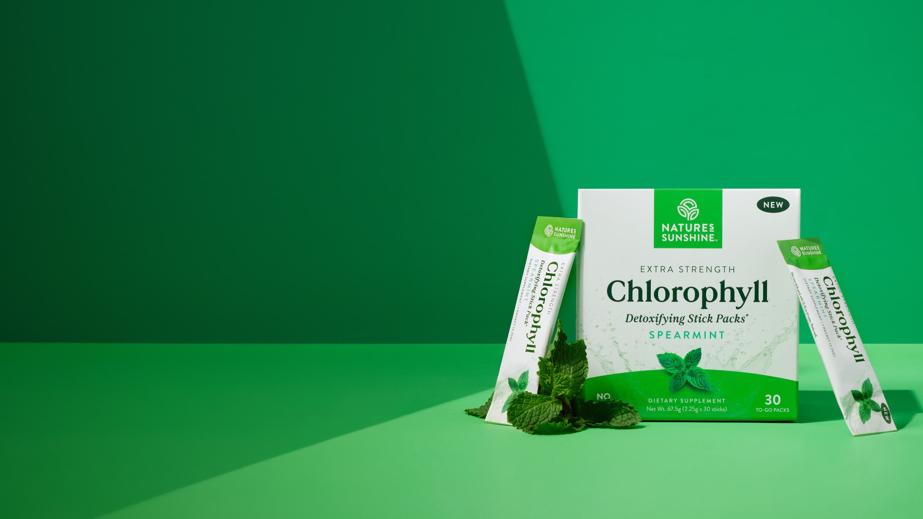 Box of Nature's Sunshine Extra Strength Chlorophyll Stick Packs on a green background